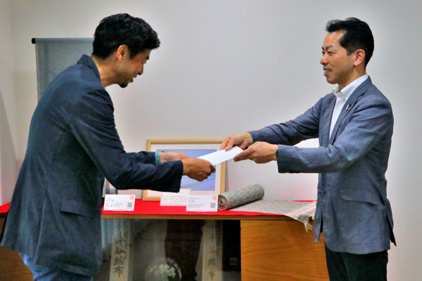 若松さんへ委嘱状を渡す市長の画像
