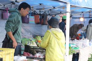 収穫祭で野菜を買う市民