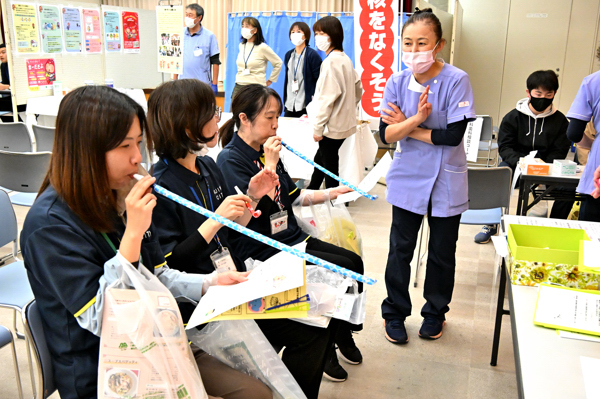 吹き戻しトレーニングを行う来場者の画像