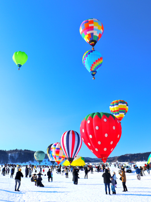 雪原に膨らんだ気球と浮かぶ気球が写っている写真